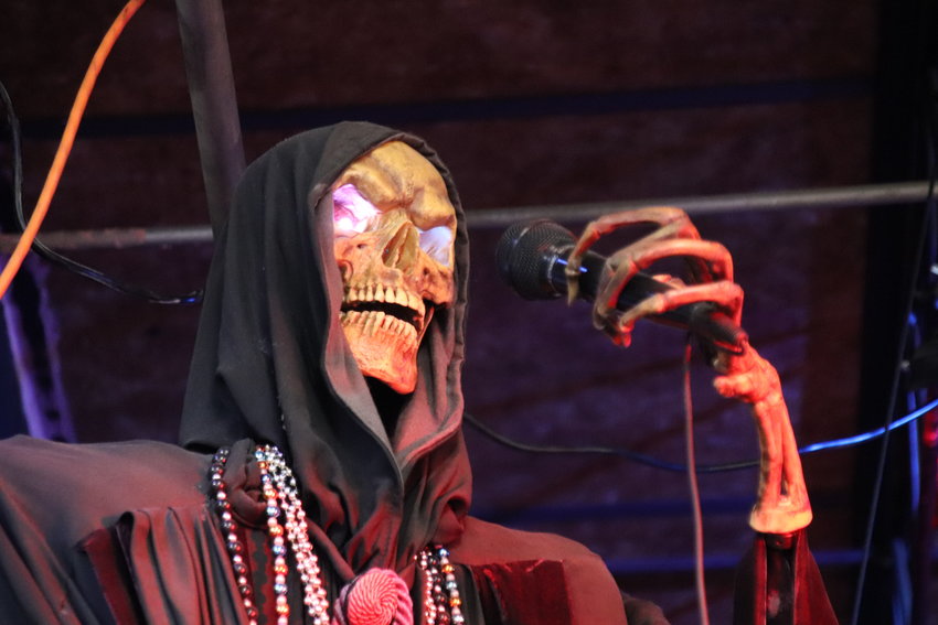 A cursed reaper sings his favorites for a live audience inside the store.
